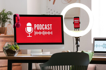 Podcaster's workplace with gadgets and glowing ring light in studio