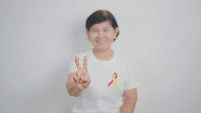 World hepatitis day awareness month, 28 July. elderly woman with Red and Yellow ribbon. Liver cancer, Jaundice, Cirrhosis, Failure, Enlarged, Hepatic Encephalopathy and Health concept