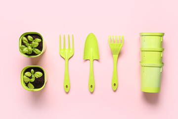 Composition with gardening tools, pots and plants on pink background