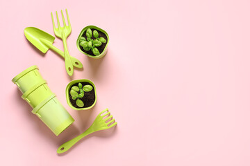 Composition with gardening tools, pots and plants on pink background
