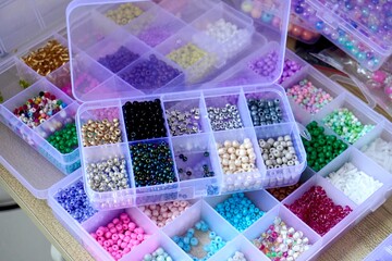 DIY art and craft seed sand beads or manik pasir inside storage boxes isolated on horizontal ratio...