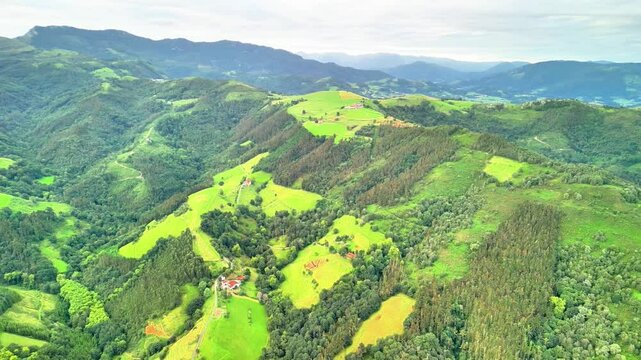 The breathtaking aerial landscape showcases vibrant green hills interspersed with serene, tranquil valleys