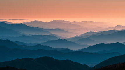 Fototapeta premium Peaceful sunrise casting golden light over misty layered mountains, tranquil morning landscape, soft haze, scenic nature view, ideal for travel and wellness themes.
