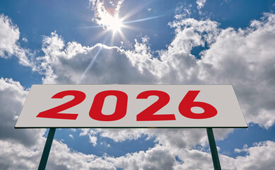 Bright sky with clouds and a large sign displaying the year 2026 under the sunlight