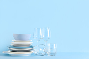Set of clean kitchenware on blue background