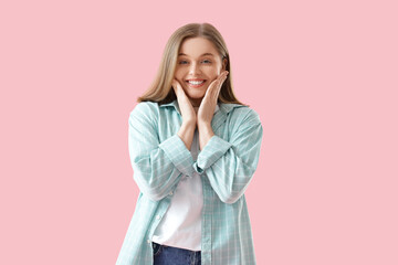Young woman with beautiful smile on pink background