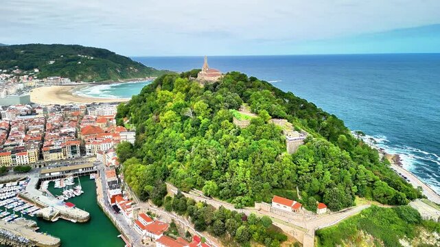 This stunning aerial shot beautifully showcases the picturesque Monte Igueldo, dramatically overlooking La Concha Beach