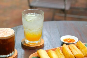 A glass of tropical ice drink for summer. Consist of passionfruit juice, lime juice, mint and soda....