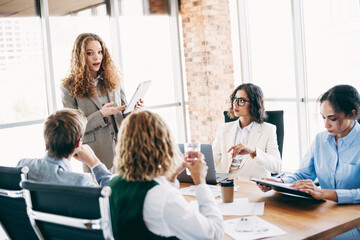 Professional collaboration of a diverse group of businesspeople engaged in a corporate meeting in a modern office setting