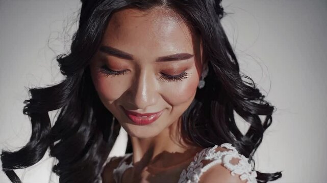 Elegant Beauty: A close-up of a woman with long, wavy black hair, showcasing her beauty, captivating with a gentle smile and delicate details.