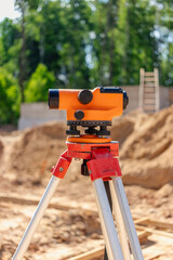 Construction site leveling instrument in use during bright day