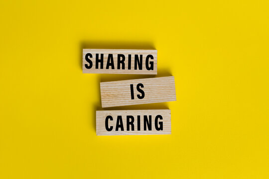 sharing is caring words text on wooden blocks isolated on yellow background