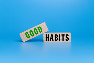 good habits words symbol on wooden blocks isolated on white ang green background. motivational words concept