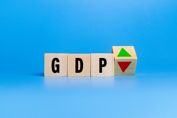 gross domestic product or GDP letter symbol with red down and green raise arrow on wooden blocks isolated on blue background. concept of growth business financial of country