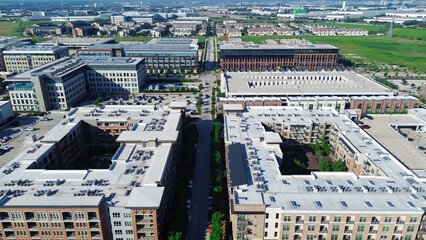 Modern apartment complex central courtyard and flat roof commercial HVAC units packages, surrounded...