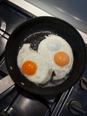 Two fried eggs on the pan.