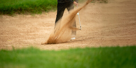 A man is playing golf and has just hit the ball