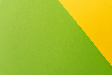 Soft diagonal layout of lime and yellow paper, modern background texture. High quality photo