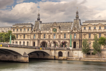 Naklejka premium Louvre Museum and Pont du Carrousel bridge over Seine River in Paris