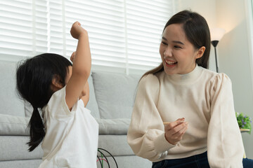 Fototapeta premium Mother day, Happy mother playing with the little girl. Funny family is happy and excited in the house. mother and daughter have fun spending time together. holiday, weekend, IQ, EQ, meditation