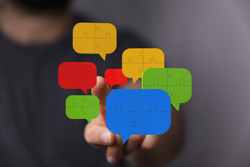 Visual of puzzle pieces forming communication bubbles, teamwork, solutions.