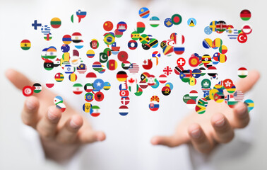 Image of hands gently cradling numerous flags, symbolizing global unity and international collaboration.