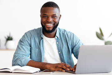Portrait Of Smiling Successful African American Male Entrepreneur Posing At Workplace In Modern...
