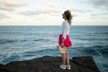 young beautiful woman on the ocean shore	

