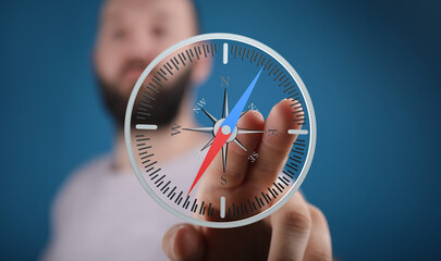 A man interacts with a digital compass, finding his way.  Concept for guidance, direction, and...