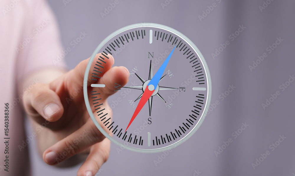 Poster Hand interacting with a digital compass, showing direction and navigation. Perfect for technology, travel, and guidance concepts.