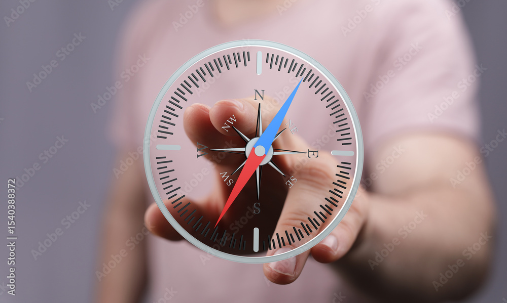 Poster a hand interacts with a digital compass, illustrating navigation, direction, and guidance.
