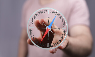 A hand interacts with a digital compass, illustrating navigation, direction, and guidance.