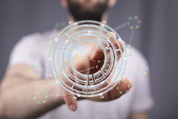 A person uses a futuristic interface to view and analyze data, represented as a holographic circular chart.