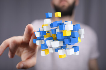 Abstract image of hand interacting with floating data cubes.  Represents digital transformation,...