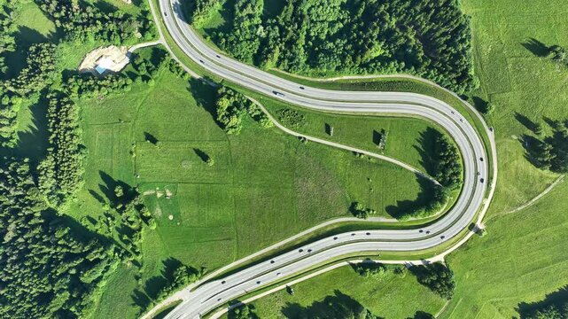 Poland. Winding switchback road from Krakow to Zakopane, called Zakopianka, near Rabka and Chabowka. Aerial 4K time lapse (speed x 4) video from above in summer with traffic