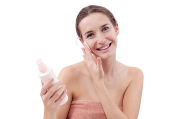 Smiling young woman cleansing her face with cotton pad and micellar water. Skincare routine, makeup...