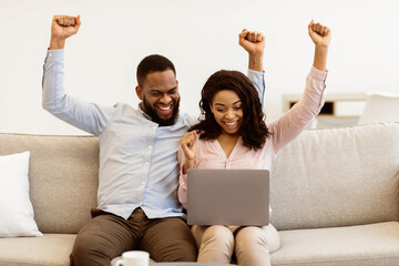 Celebrating Success. Overjoyed african american man and woman happy with money win, satisfied about...