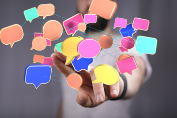 Person interacting with a network of colorful speech bubbles, symbolizing global communication and...