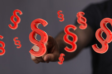 Abstract image of a hand and floating paragraph symbols. Ideal for legal, law, and regulation...