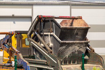Double skip dump metal container used for disposal of dig up waste material in construction industry outside on a street