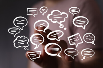 Abstract image of hand interacting with digital speech bubbles. Represents communication, social...