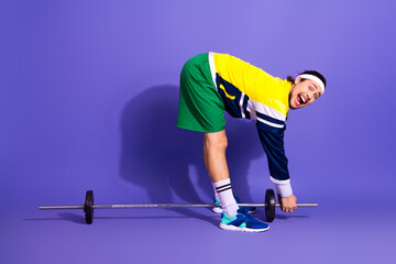 A young athlete in retro sportswear practices weightlifting with enthusiasm against a vibrant...