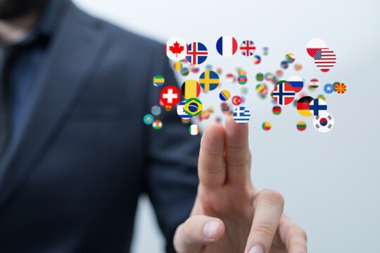 Businessman touching digital interface showing flags of various countries. Global network concept.