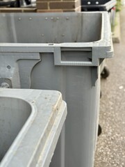 A Row of Industrial Waste Bins Equipped with Wheels for Easy Transportation and Use. A set of...