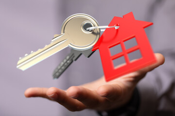 Image of house keys on an open hand. Perfect for real estate, home buying, and ownership concepts.