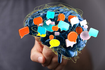 Abstract image of a brain with colorful speech bubbles, symbolizing communication, ideas, and...