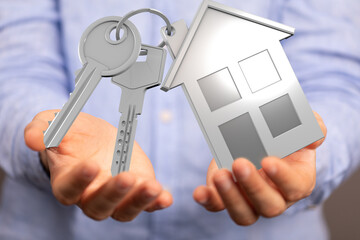 Image of hands holding house keys and a house model. Perfect for real estate, home buying, and new...