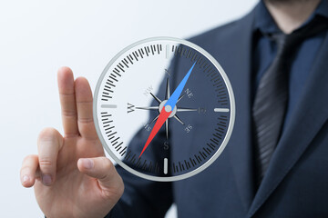 Stock photo of a businessman using a virtual compass, symbolizing strategic planning and...