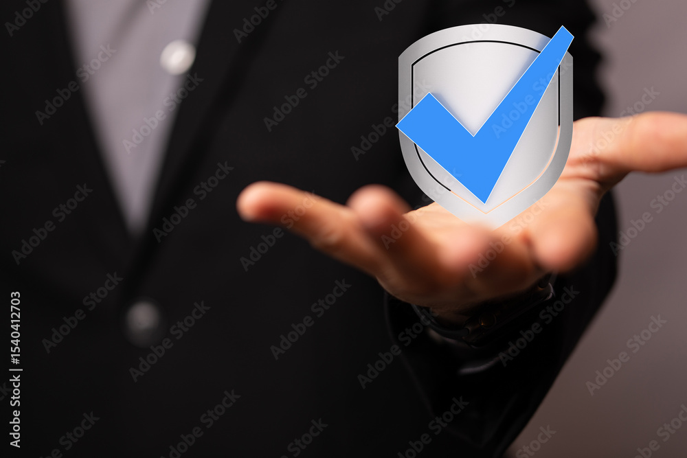 Poster Image of a person in a suit presenting a digital security shield with a checkmark, symbolizing protection and trust.