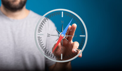 A man interacts with a digital compass, illustrating guidance and direction. Ideal for navigation,...